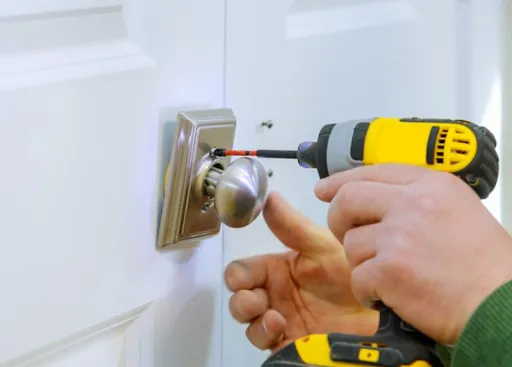 Professional locksmith installing door lock with precision tools